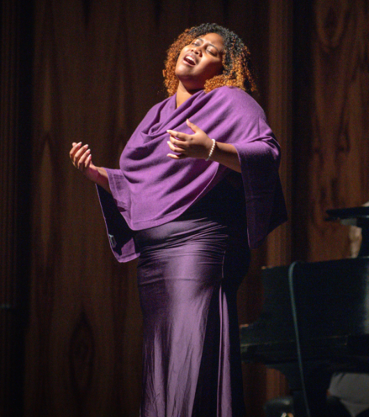 African American Opera singer wearing a purple gown